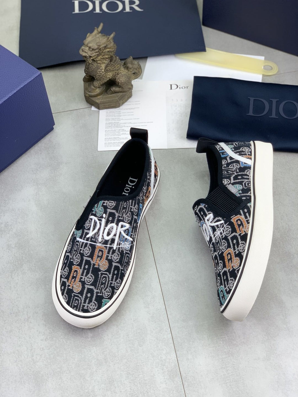 Dior Graphic Canvas Slip-On Sneakers - Black, White and Tan